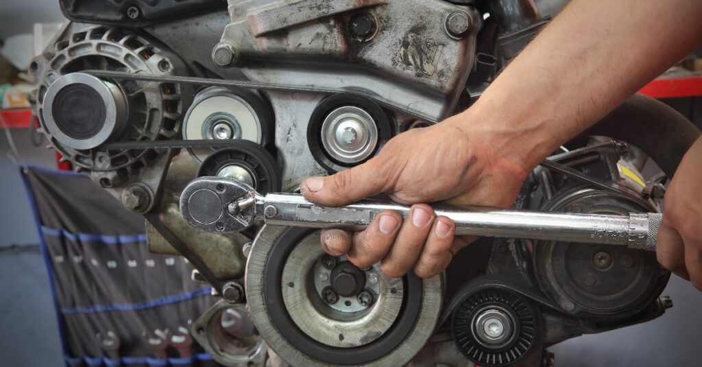 DME Auto Technician Repairing Car Alternator