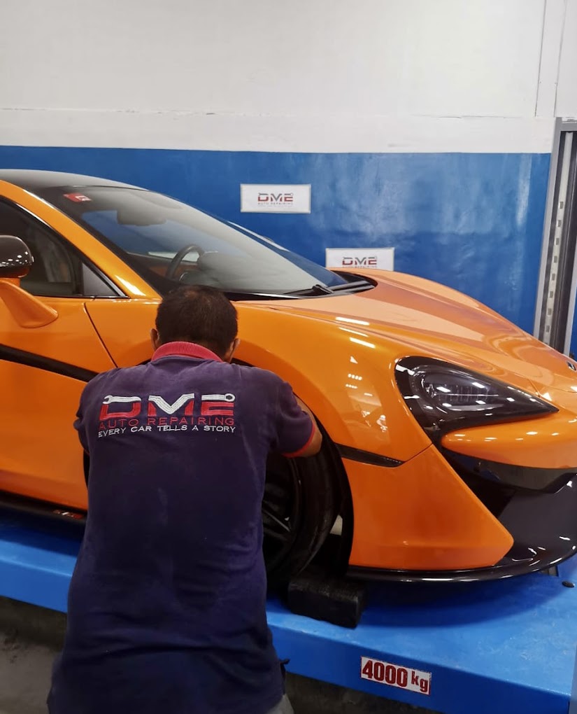 Mechanic Repairing Mclaren suspension at DME Auto Garage