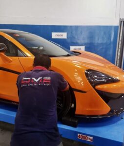 Mechanic Repairing Mclaren suspension at DME Auto Garage