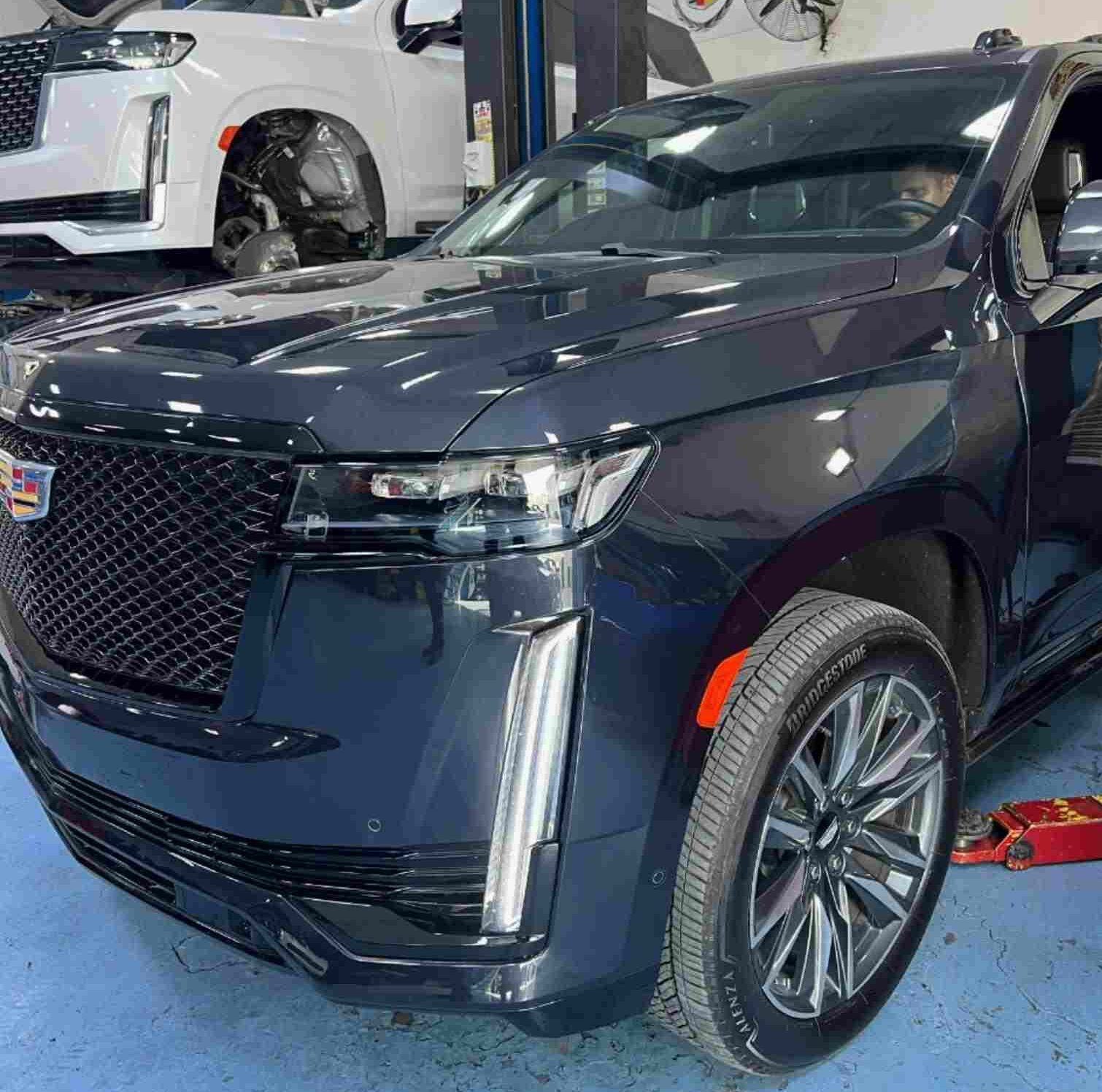 DME Mechanic Team is repairing a black Cadillac Escalade